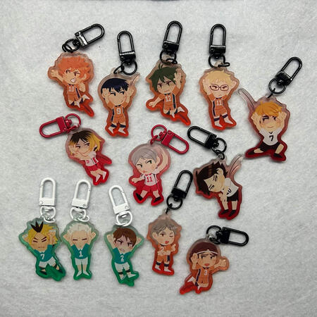 other side of the double-sided keychain designs of several characters from haikyuu